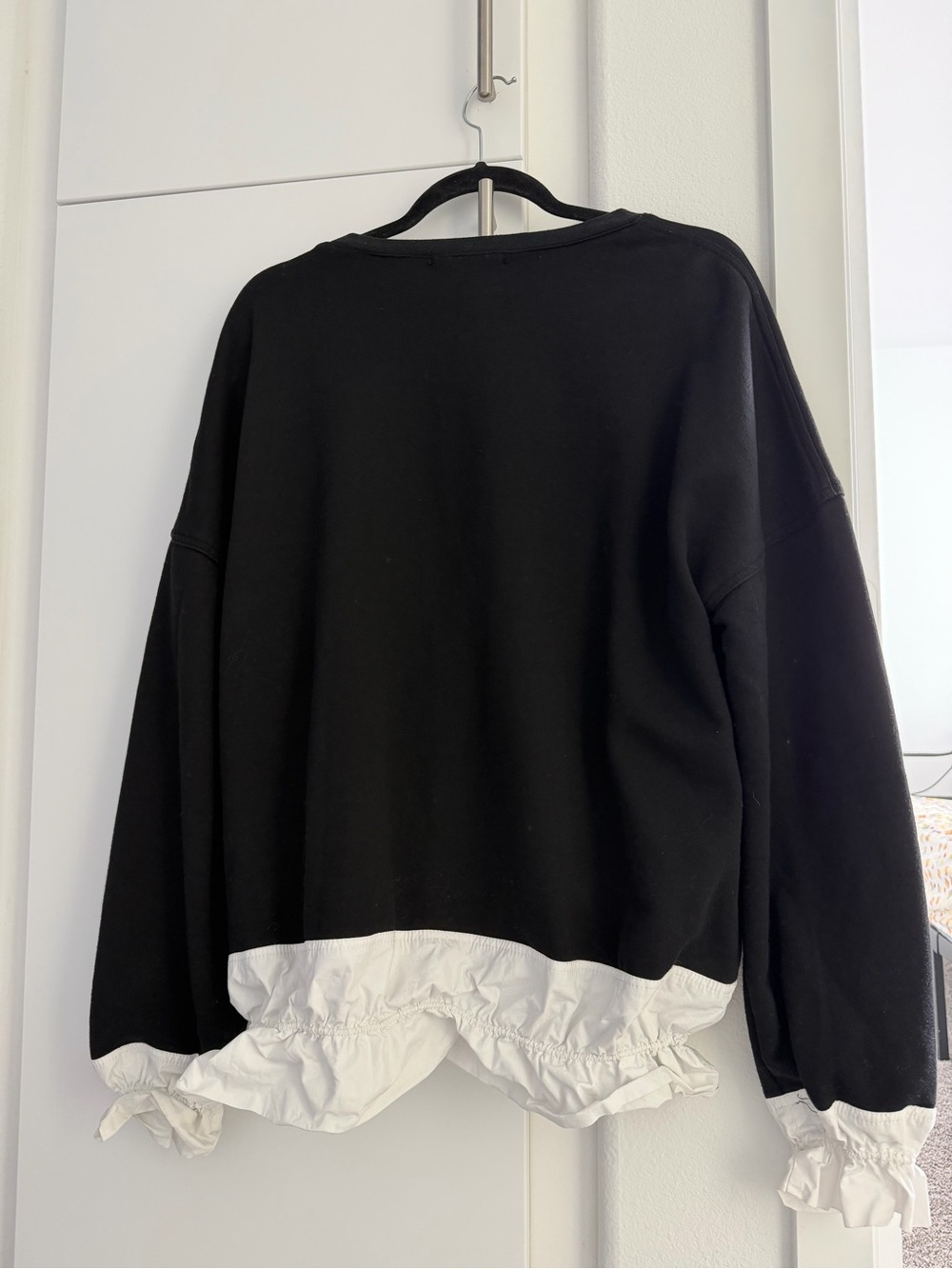 Black Pullover Sweatshirt with White Ruffle Hem
